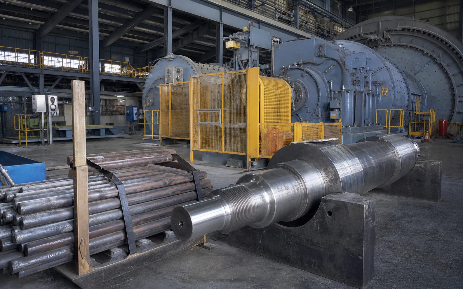 Heavy rod-mill and crusher drive environment with large shafts and grinding rods visible
