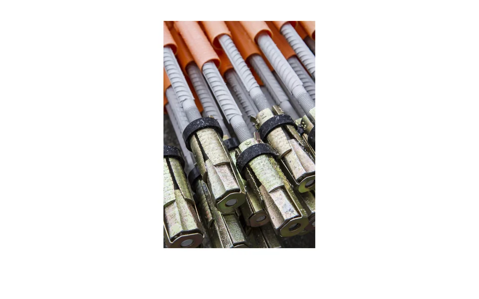 Manufacturer photograph of steel combination-bolt expansion heads, threaded rods and protective sleeves