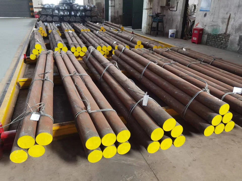 Bundles of grinding rods with yellow-painted ends in a workshop