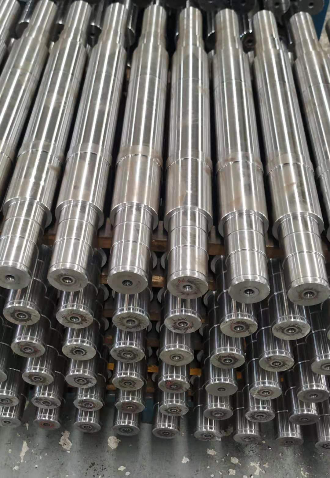 Machined steel shaft bars shown for downstream cleanup allowance context