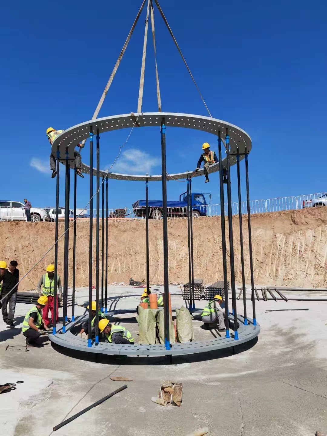 Workers installing a steel anchor cage for a wind-foundation project