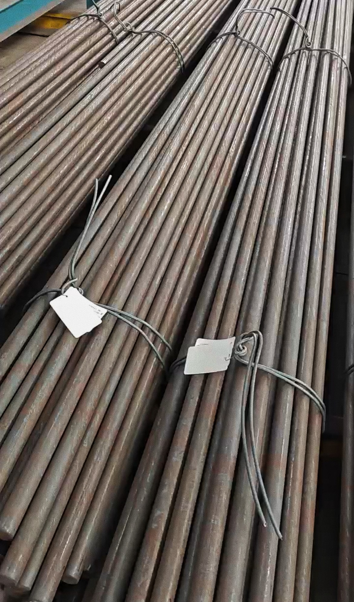 Bundles of round steel bars tied with identification tags