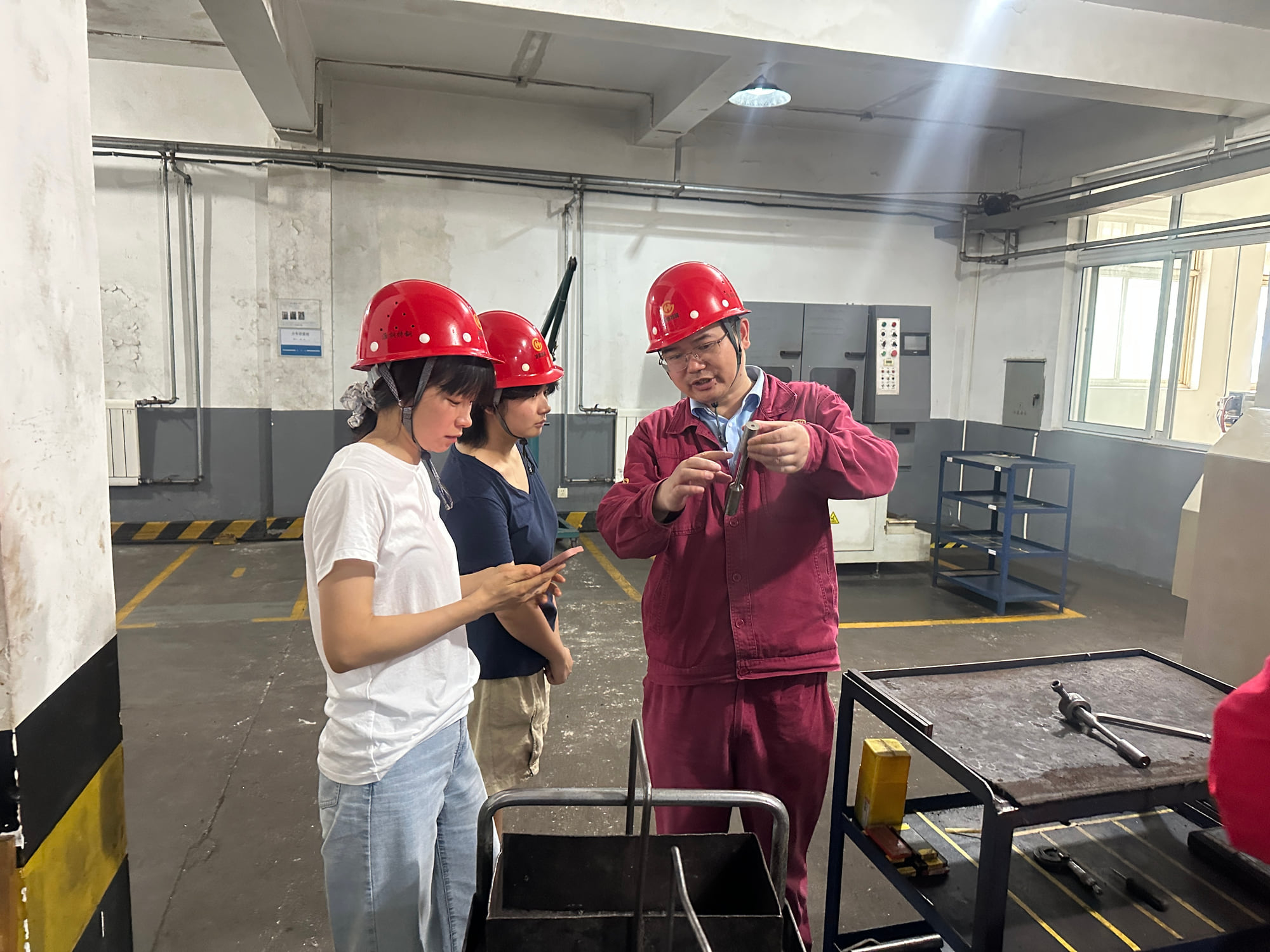 Quality team reviewing a prepared steel test specimen in the laboratory