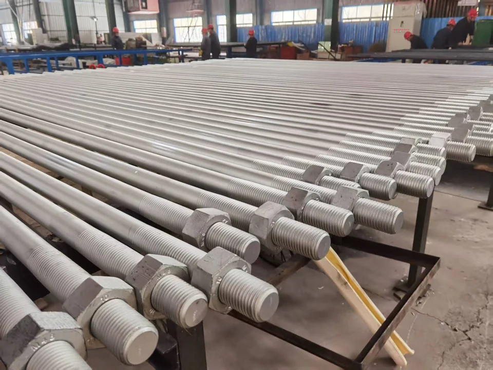 End-threaded steel bars with nuts arranged in a workshop